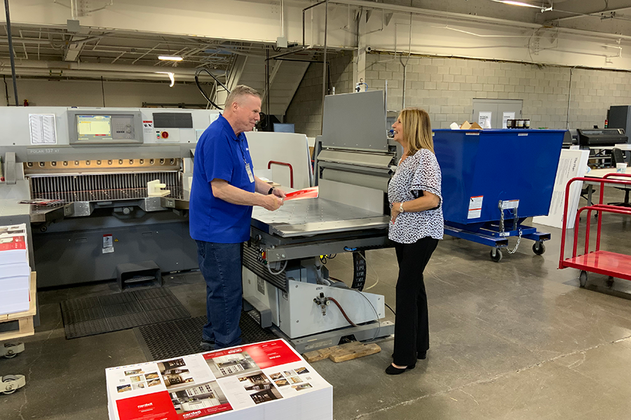 People Standing Around Printer Cutter